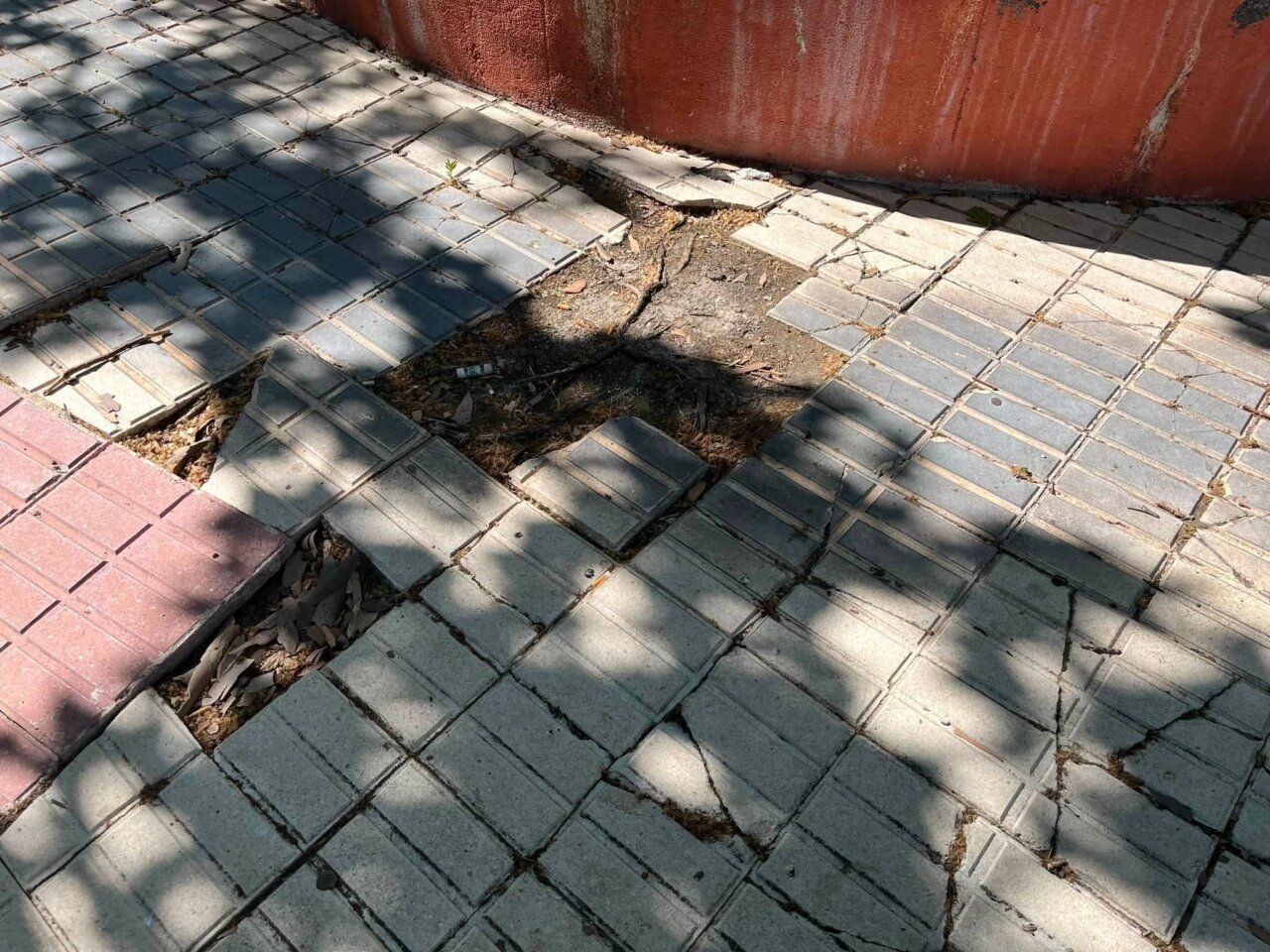 Pavimento deteriorado con baldosas rotas y hundidas en Zamora