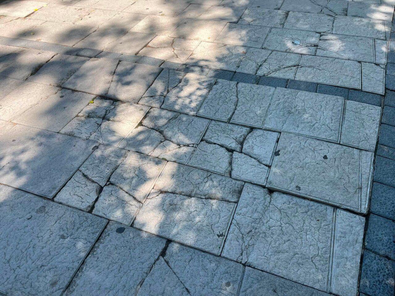 Pavimento deteriorado con baldosas rotas y hundidas en Zamora