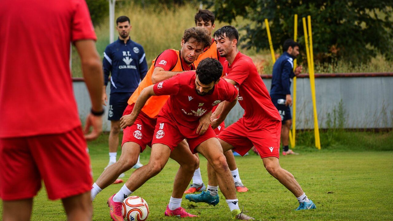 Jugadores del Zamora CF entrenando en una sesión intensa en el campo.